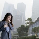 Lady coughing due to the haze in Singapore